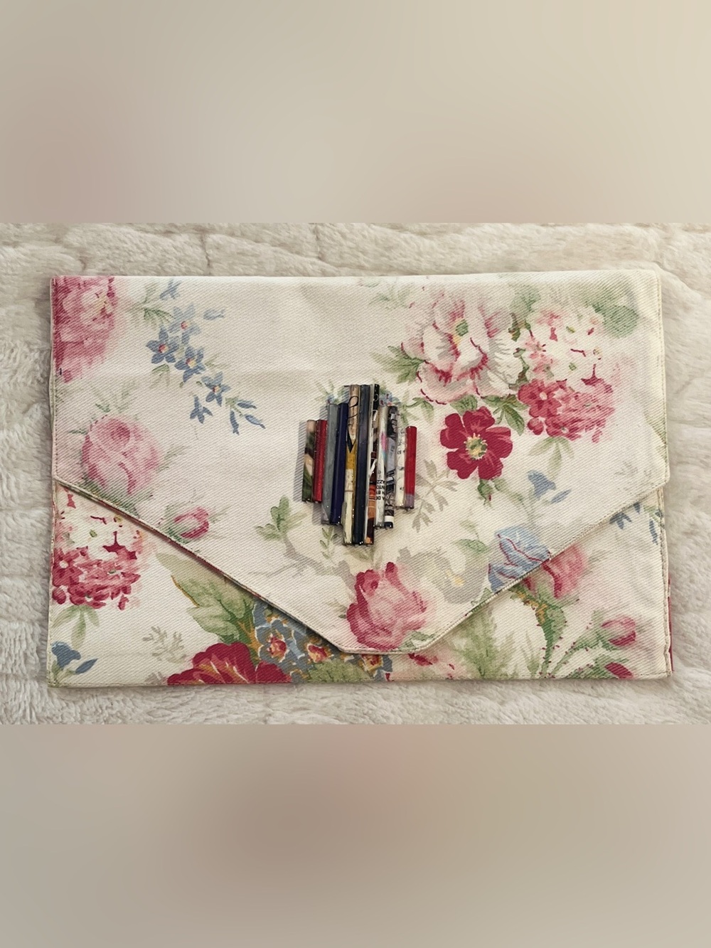 Bohemian -style envelope clutch features a delicate floral print.